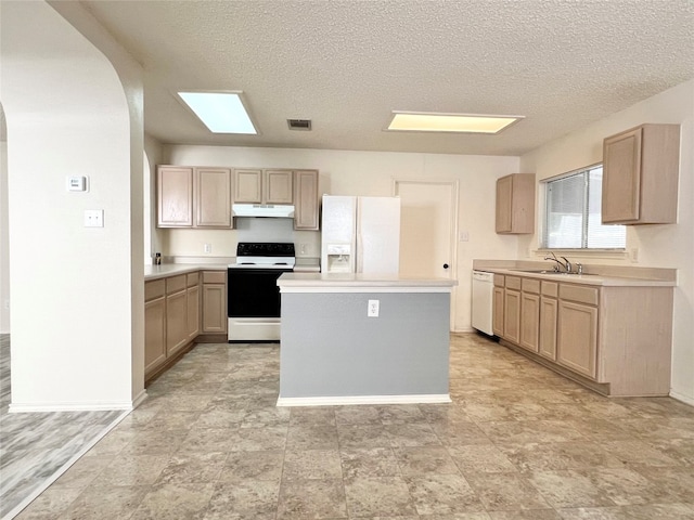 kitchen featuring light brown cabinets, a textured ceiling, sink, and white appliances