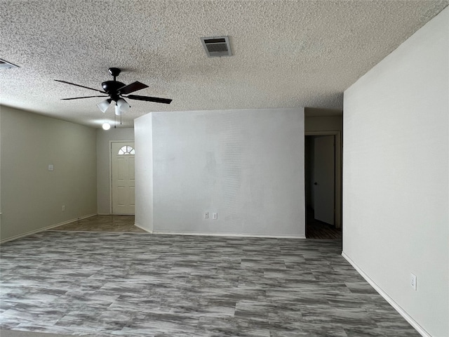 unfurnished room featuring a textured ceiling and ceiling fan