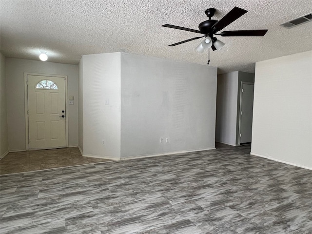 entrance foyer featuring ceiling fan and a textured ceiling