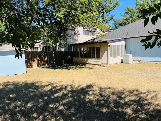 view of yard featuring cooling unit and a sunroom