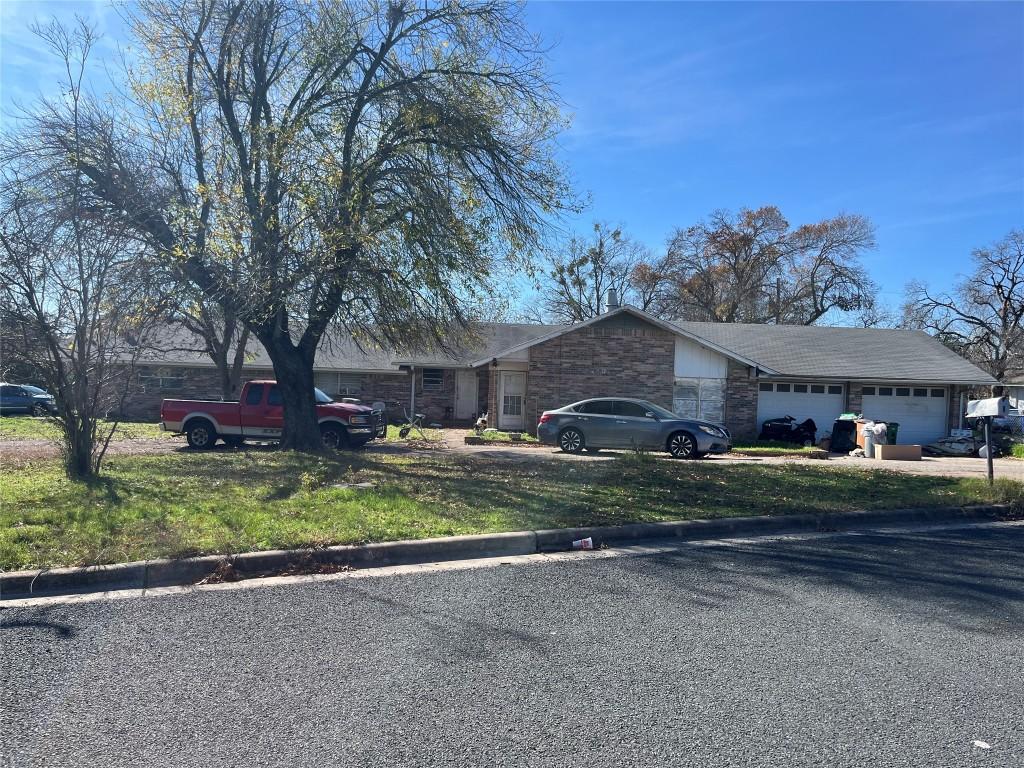 1701 Shadowview Dr, Austin, TX 78758 - single story home with a garage, stone siding, and driveway