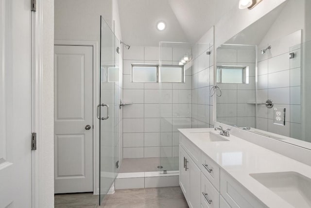 bathroom with lofted ceiling, an enclosed shower, vanity, and tile patterned flooring