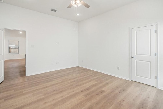 spare room with ceiling fan and light wood-type flooring