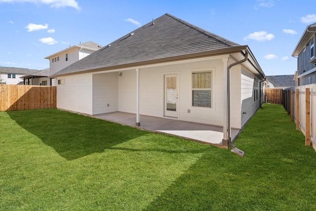 back of house featuring a yard and a patio