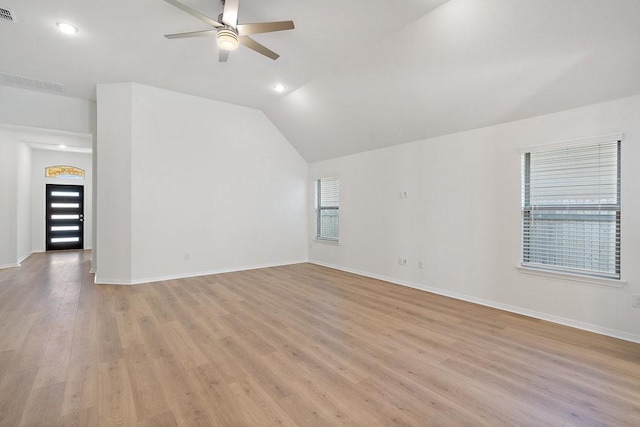 spare room with vaulted ceiling, light hardwood / wood-style floors, and ceiling fan