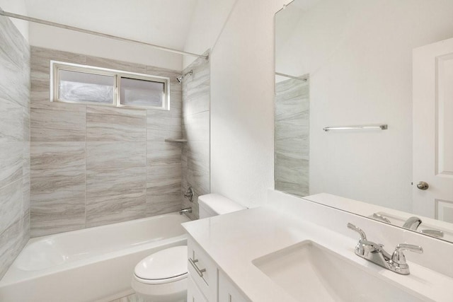 full bathroom with tiled shower / bath, vanity, and toilet