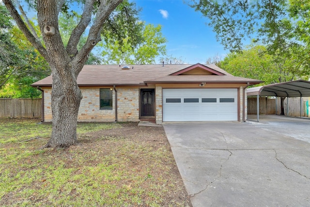 ranch-style house with a front yard, a garage, and a carport