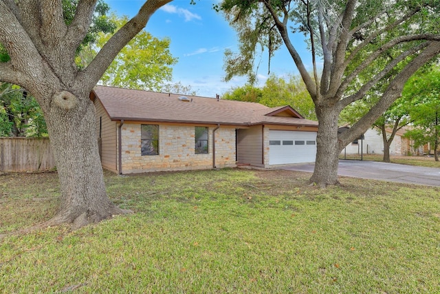 single story home with a front yard and a garage