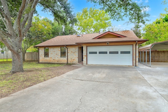 view of front of property featuring a carport, a front lawn, and a garage