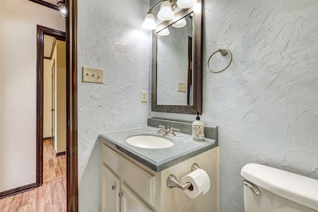 bathroom featuring vanity, hardwood / wood-style floors, and toilet