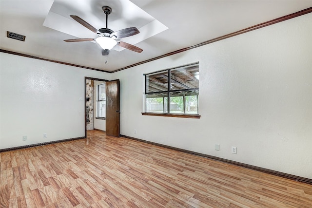 unfurnished room with ornamental molding, light wood-type flooring, and ceiling fan