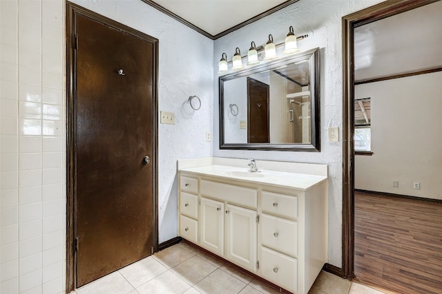 bathroom with vanity, ornamental molding, and wood-type flooring