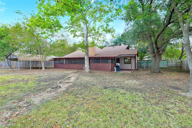 back of house with a yard