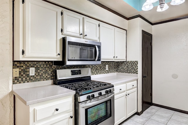 kitchen featuring decorative backsplash, white cabinetry, and stainless steel appliances