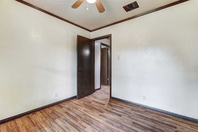 spare room featuring light hardwood / wood-style flooring, ceiling fan, and crown molding