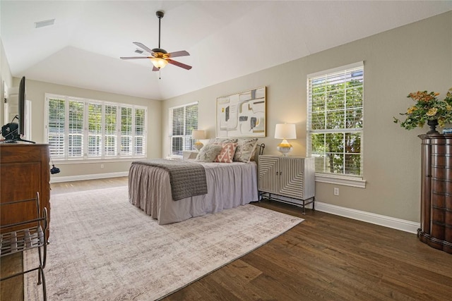 bedroom with dark wood-type flooring, ceiling fan, lofted ceiling, and multiple windows