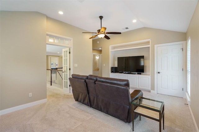 carpeted living room with ceiling fan and lofted ceiling