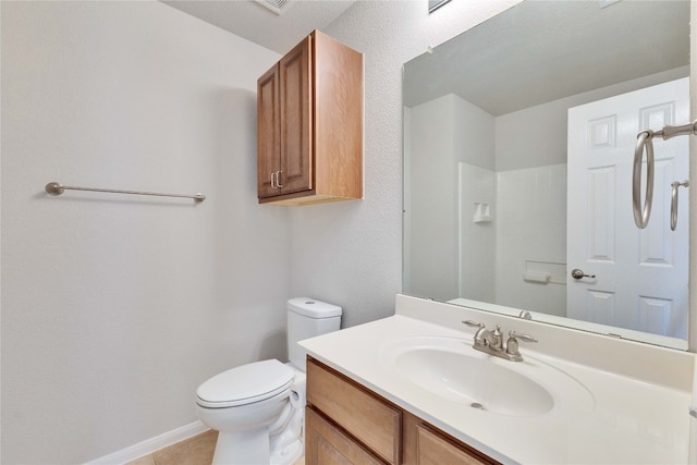 bathroom featuring toilet, vanity, and tile patterned flooring