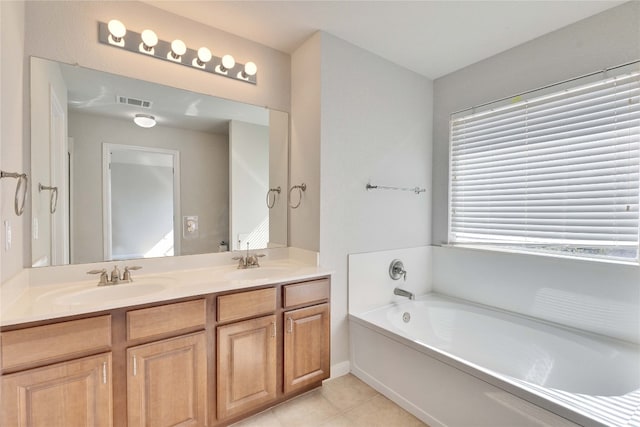 bathroom with vanity, tile patterned floors, and a bathing tub