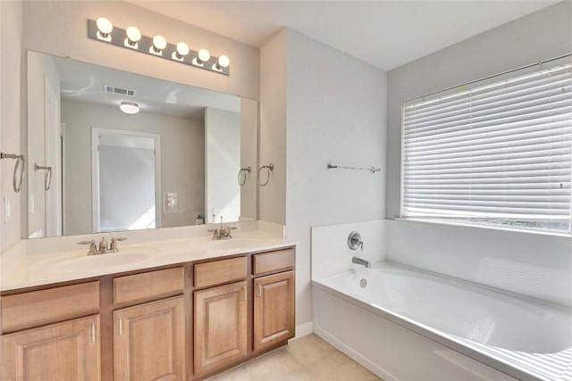 7537 S Glenn St, Austin, TX 78744 - full bathroom with a garden tub, tile patterned floors, and double vanity