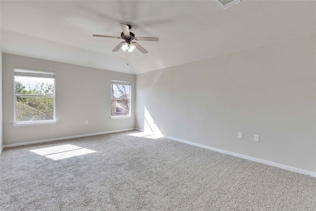 carpeted empty room with vaulted ceiling and ceiling fan