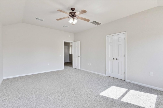 7537 S Glenn St, Austin, TX 78744 - unfurnished bedroom featuring light colored carpet, lofted ceiling, baseboards, ceiling fan, and a closet