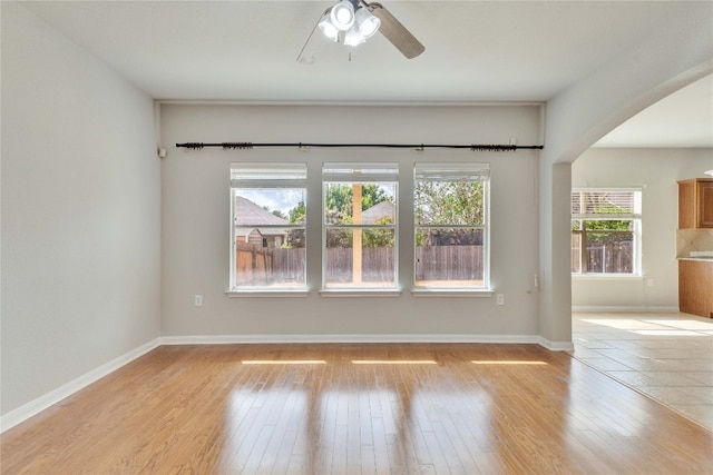 empty room featuring light wood-type flooring and ceiling fan