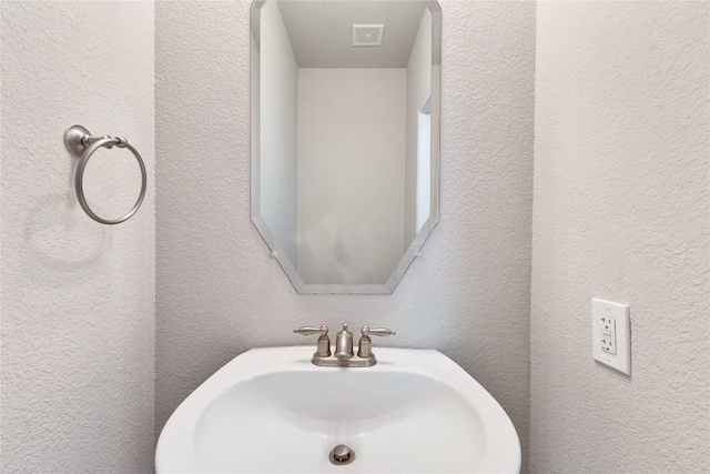 7537 S Glenn St, Austin, TX 78744 - bathroom with a sink and a textured wall