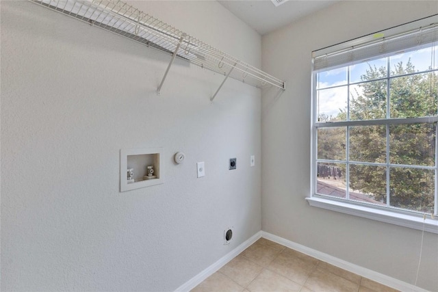 7537 S Glenn St, Austin, TX 78744 - washroom featuring hookup for an electric dryer, washer hookup, light tile patterned flooring, baseboards, and gas dryer hookup