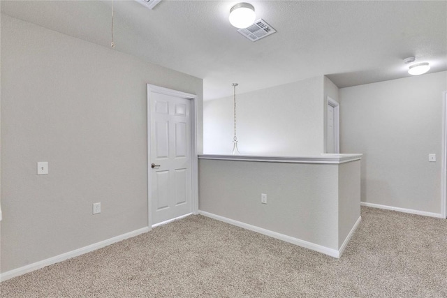 7537 S Glenn St, Austin, TX 78744 - spare room with light colored carpet, baseboards, and attic access