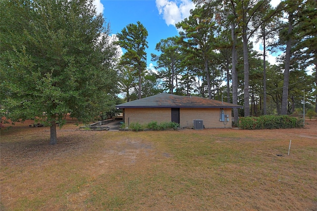 exterior space featuring a yard and cooling unit