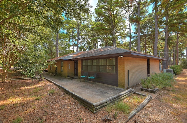 view of property exterior with a patio area