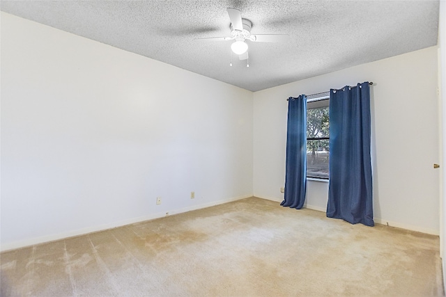 carpeted empty room featuring a textured ceiling and ceiling fan