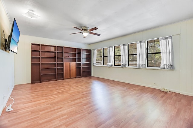 unfurnished living room with light hardwood / wood-style floors, a healthy amount of sunlight, and ceiling fan