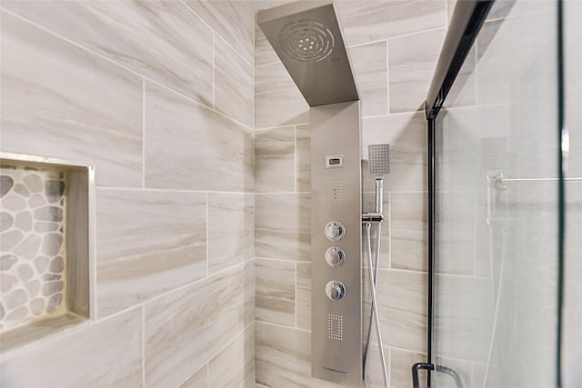 bathroom with a shower with door