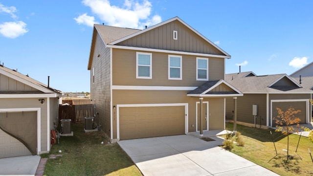 view of front of property featuring cooling unit, a front lawn, and a garage