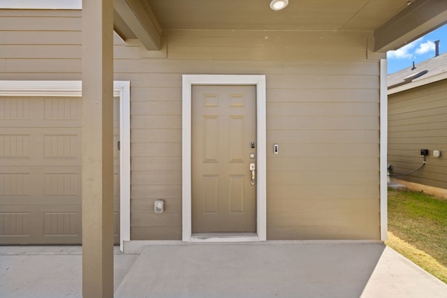 doorway to property with a garage