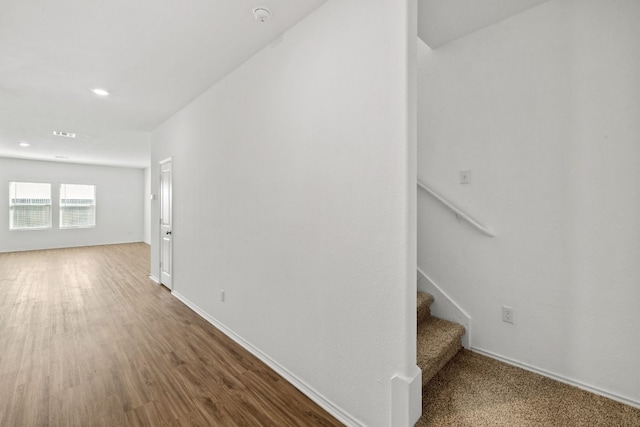 stairs with hardwood / wood-style floors