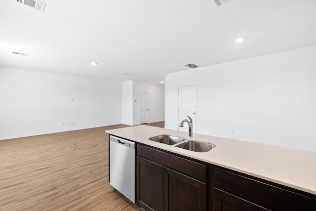 kitchen featuring stainless steel dishwasher, sink, dark brown cabinetry, and light wood-type flooring