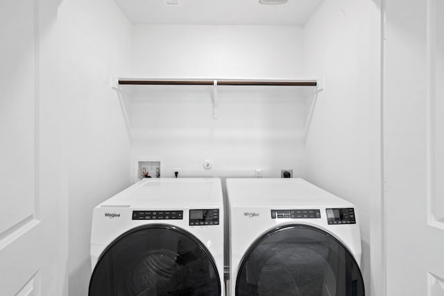 clothes washing area featuring washer and clothes dryer