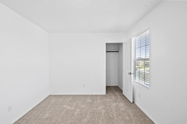 unfurnished bedroom featuring light carpet