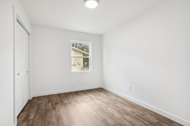 unfurnished bedroom featuring hardwood / wood-style flooring and a closet