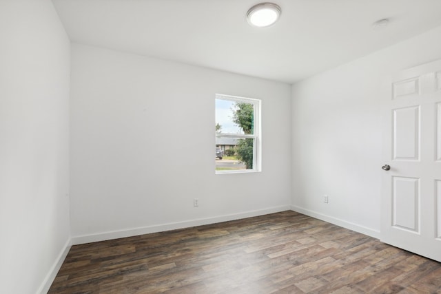 empty room featuring dark wood-type flooring