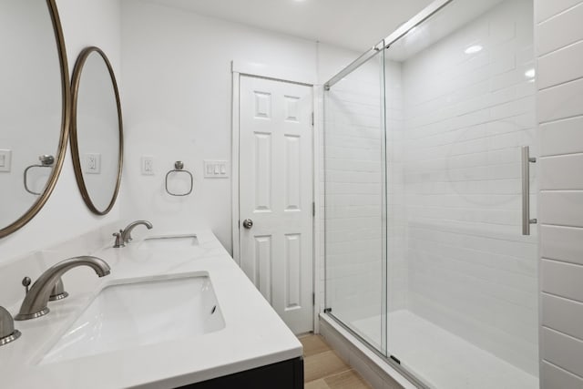 bathroom with vanity and a shower with shower door