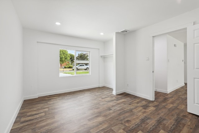 empty room featuring dark hardwood / wood-style flooring