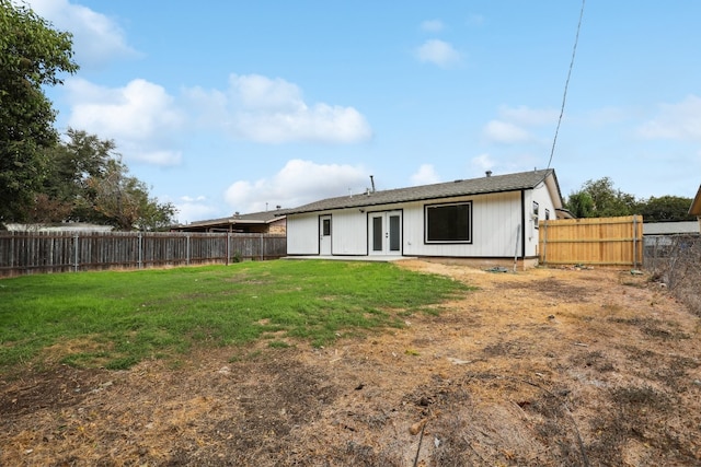 rear view of house featuring a lawn