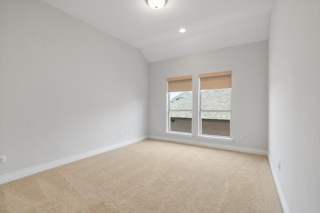 18201 Hewetson Cv, Austin, TX 78738 - unfurnished room with light carpet, baseboards, lofted ceiling, and recessed lighting