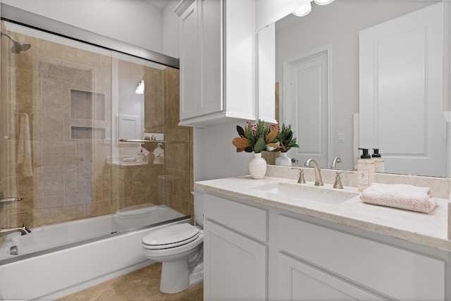 full bathroom featuring vanity, toilet, tile patterned floors, and combined bath / shower with glass door