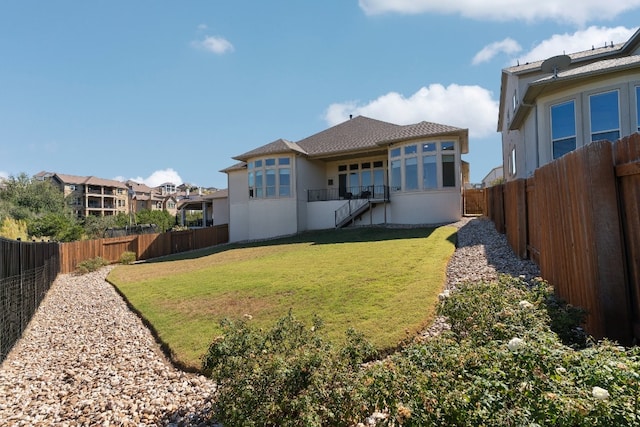 rear view of house featuring a yard