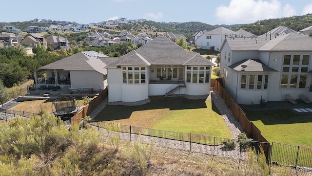 rear view of property with a patio, a mountain view, and a lawn